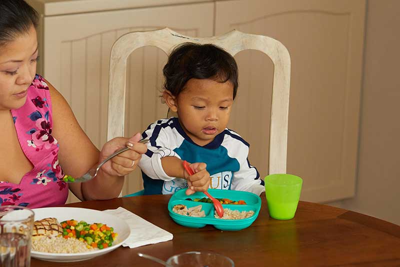 toddler eating family meal